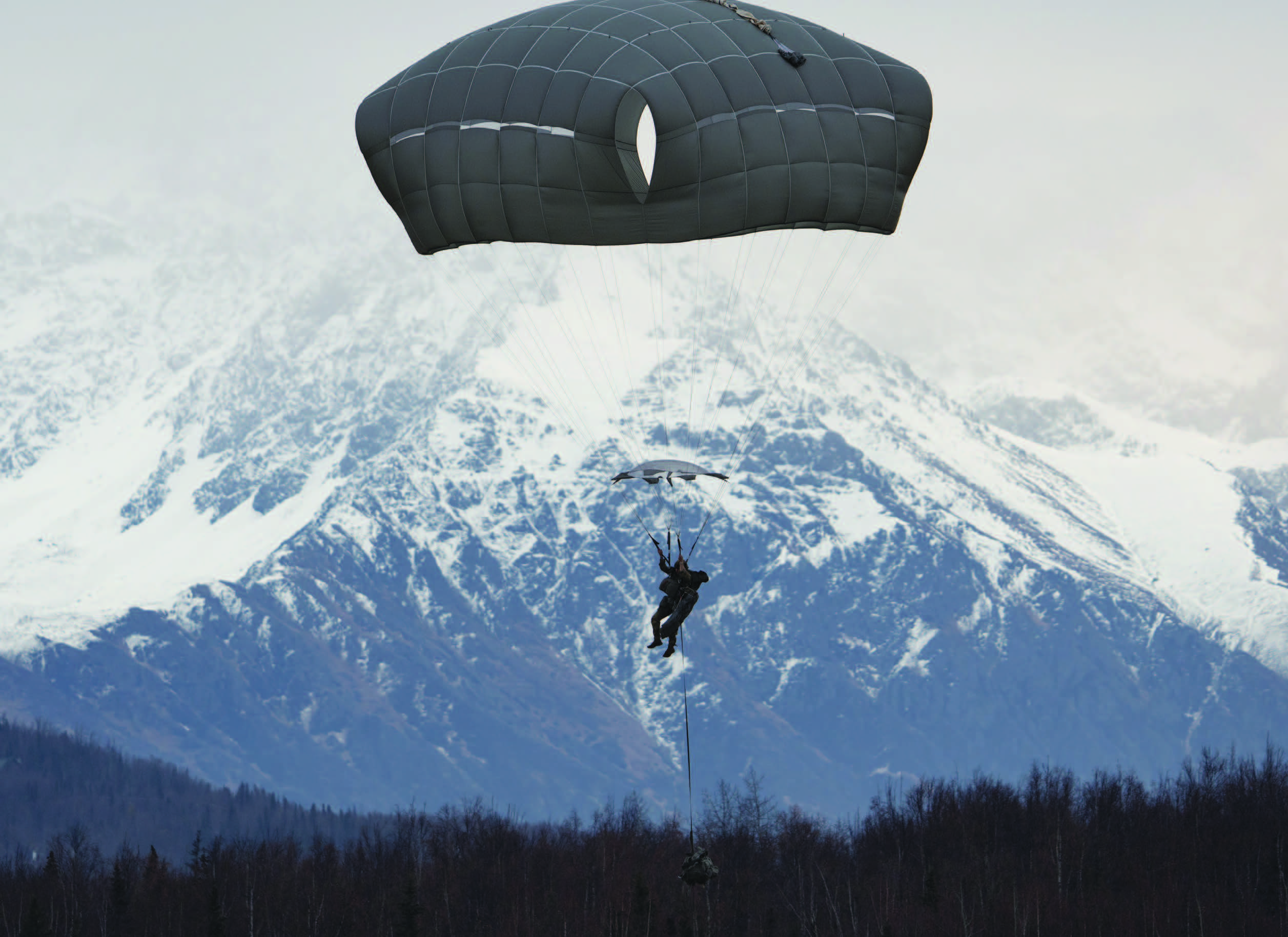 Army paratrooper with 1st Battalion, 501st Parachute Infantry Regiment, 2nd Infantry Brigade Combat Team (Airborne), 11th Airborne Division, “Arctic Angels,” descends while conducting joint forcible entry operation at Malemute Drop Zone, Joint Base Elmendorf-Richardson, Alaska, during Arctic Aloha, November 2, 2023 (U.S. Air Force/Julia Lebens)